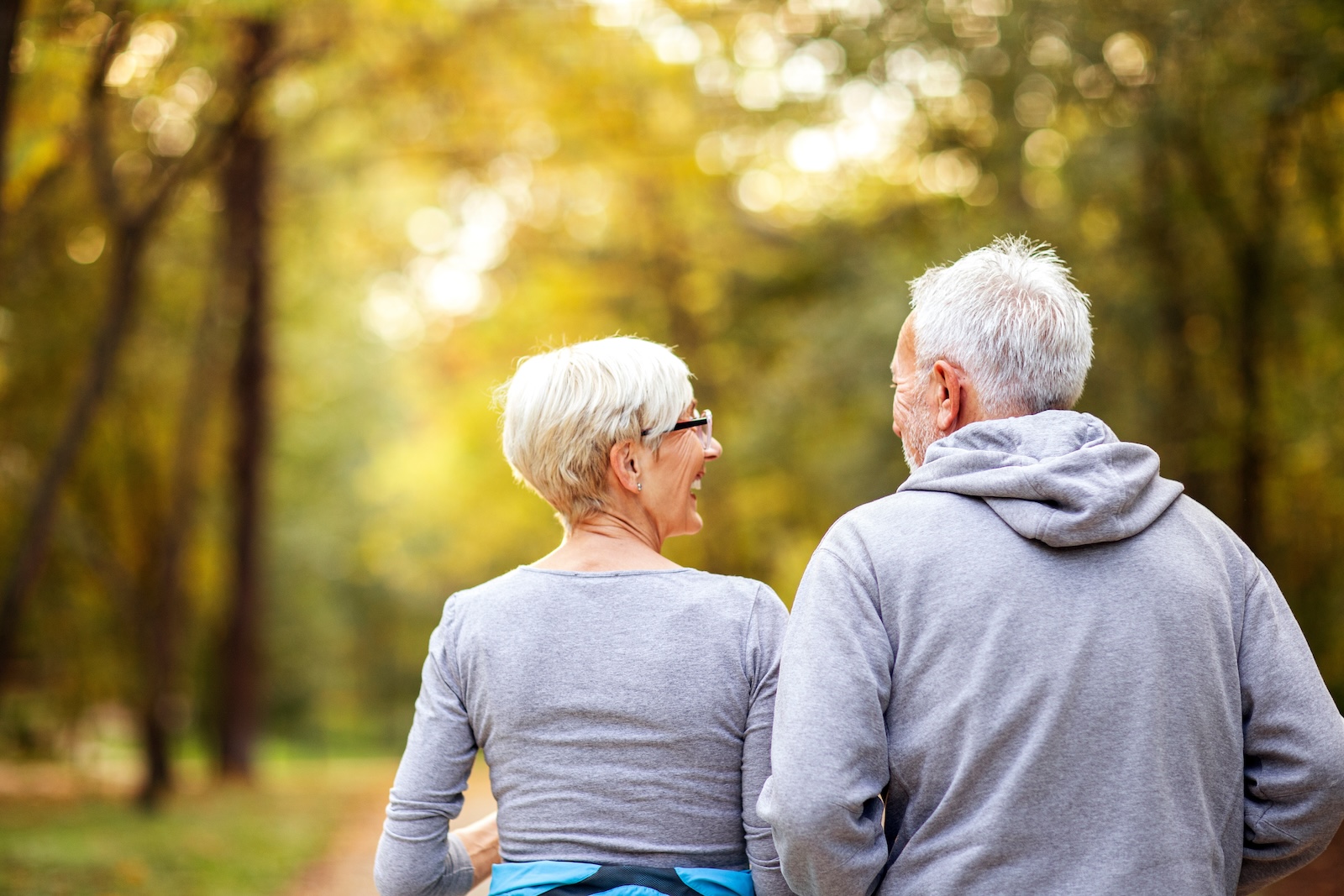 Mature couple man and woman jogging in the park