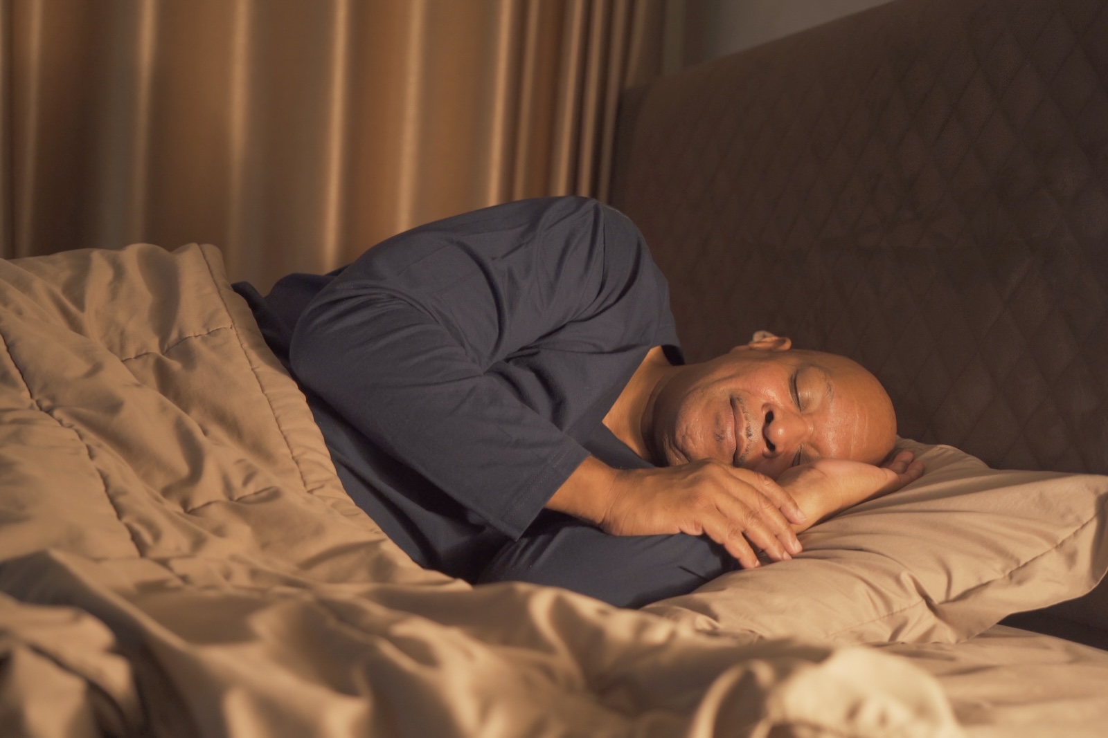 Older Afican American Man Happily Sleeping