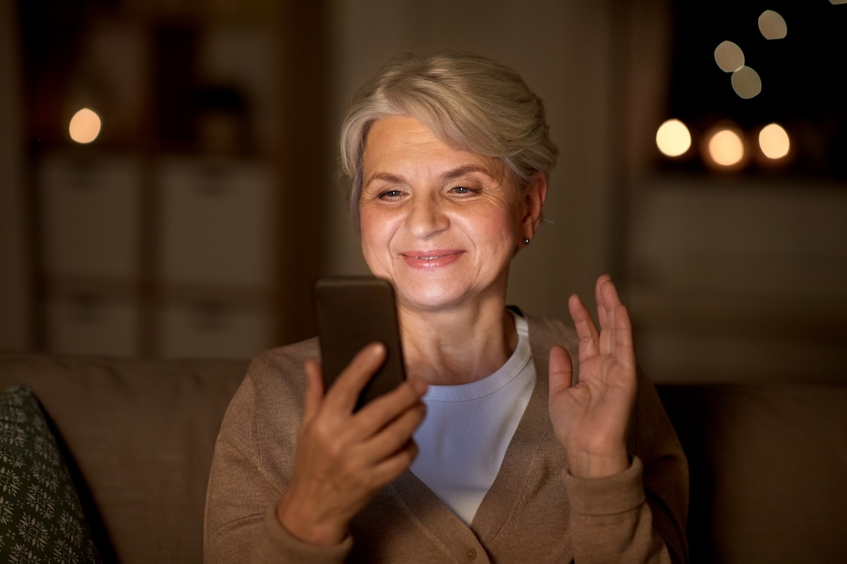 happy old woman with smartphone having video call